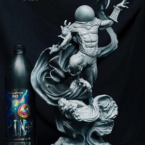 May include: A grey 3D-printed statue of a superhero with a flowing cape and detailed design. A bottle of 3D printing resin is on the left. The statue is set against a dark background. The bottle contains 1kg of resin.