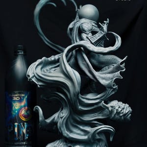 May include: A grey 3D-printed sculpture of a character with a spherical head and flowing cape. The figure is posed dynamically, with intricate details in the cape and costume. A bottle of "QUANTUM 3D" paint is next to the sculpture.