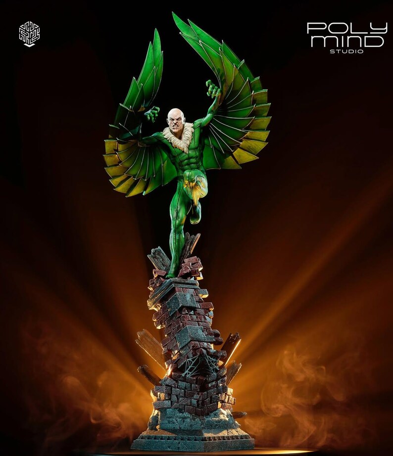 May include: A detailed statue of the Vulture, a comic book villain, with green and yellow wings outstretched. The figure is posed atop a crumbling brick structure. The statue is from Poly Mind Studio.