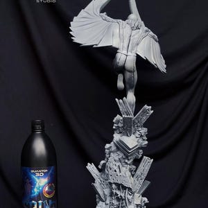 May include: A gray 3D-printed sculpture of a figure with large wings, posed mid-flight, atop a jagged, rocky base. A black bottle with blue and white label is on the left. The sculpture is labeled "POLY MIND STUDIO".