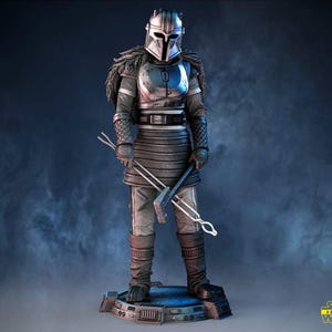 May include: A detailed figurine of a character in silver and gray armor, holding metal tools. The figure stands on a blue platform, with a helmet and fur-like accents. The Star Wars logo is visible in the bottom right corner.