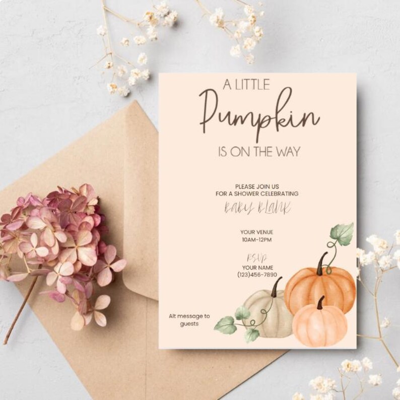 May include: A baby shower invitation with the text "A Little Pumpkin Is On The Way." The invitation features watercolor pumpkins in orange and white, with green vines. The invitation is on a peach background with a brown envelope and flowers.