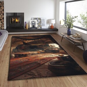 May include: A large rectangular area rug with a detailed, artistic design. The rug features a warm color palette with shades of brown, red, and tan, depicting an interior scene with a tent-like structure. The rug is placed on a wooden floor.
