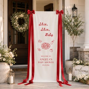 May include: A vertical white fabric banner featuring red text that reads Slice, Slice, Baby, Welcome to Angela's Baby Shower, and 09.22.2026. The banner includes red line art of a pizza, a baby bottle, a pacifier, and a tomato, with red ribbons.