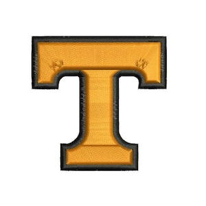 May include: Embroidered patch in the shape of the letter "T". The letter is gold with a black border and black stitching. The patch is on a white background.