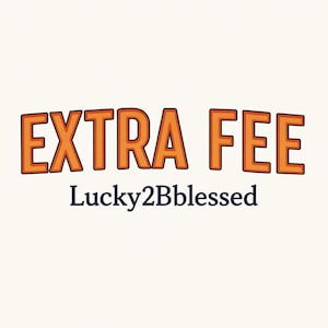 May include: Orange text on a white background reads "EXTRA FEE" with a black outline. Below the text is the phrase "Lucky2Bblessed" in a dark blue font. The text has a cartoonish style.