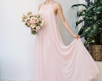 May include: A floor-length, light pink chiffon dress featuring a high halter neckline with delicate pleating at the collar. The garment has a loose, flowing silhouette that reaches the floor, crafted from a soft, semi-sheer fabric.