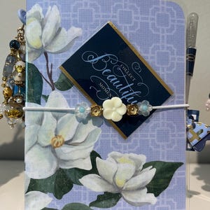 Laminated Travelers Notebook with removable inserts, file folder and tags with coordinating pen.
