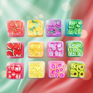 May include: A set of twelve square mechanical keyboard keycaps, each featuring a clear top layer embedded with colorful, miniature fruit slices including strawberry, pineapple, grape, lime, watermelon, lemon, dragon fruit, kiwi, and avocado.