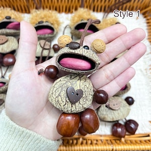 May include: Handmade bear-shaped ornaments crafted from natural materials. The bear features a light brown body, a dark brown heart-shaped button, and a pink tongue. The text "Style 1" is visible in the image.