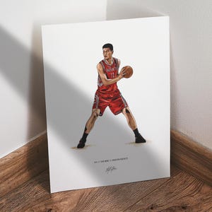 May include: A print of a basketball player in a red uniform with the number 11, holding a basketball. The player is in a stance as if about to pass the ball. The print has the text "#11 // Yao Ming // Houston Rockets" and a signature.