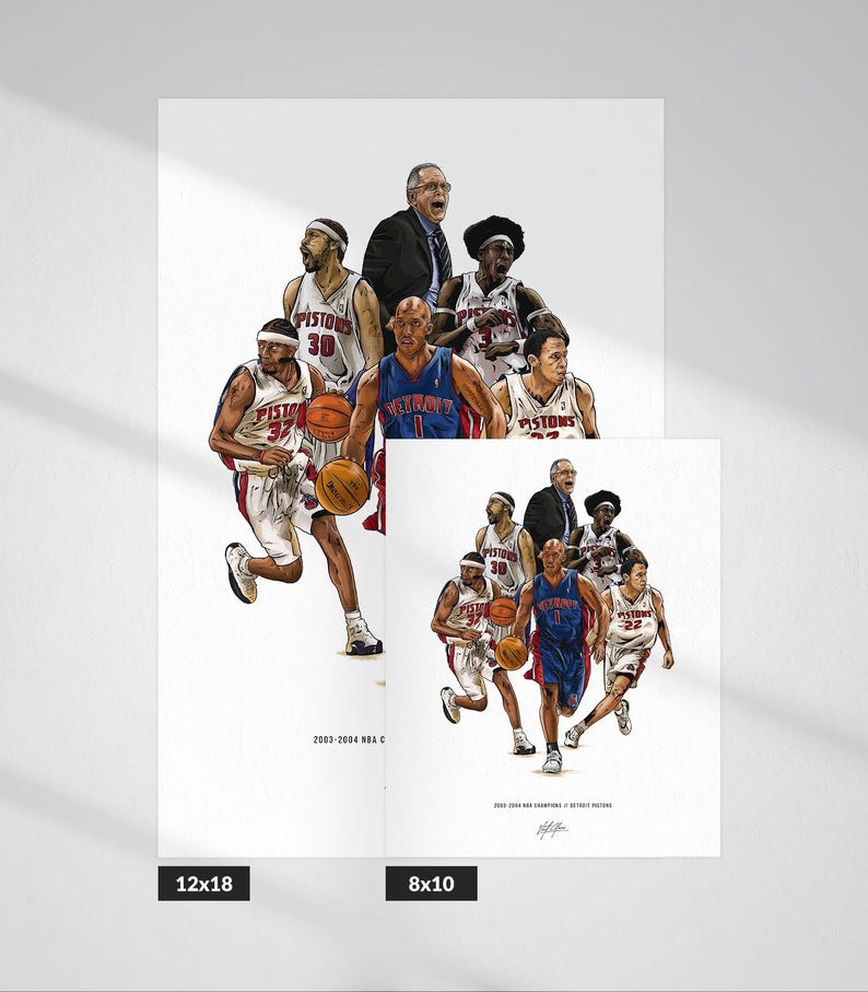 May include: A white art print featuring a detailed illustration of the 2003-2004 Detroit Pistons basketball team, including players in white and blue uniforms, a coach, and basketballs, with the text 2003-2004 NBA CHAMPIONS / DETROIT PISTONS.