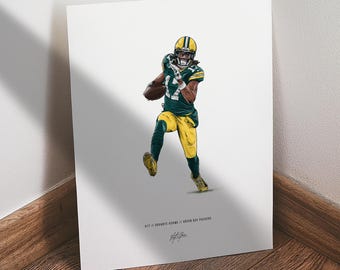 May include: Illustration of a football player in a green and yellow uniform, catching a football. The artwork features the player in action, with a dynamic pose. The print includes the text "#17 Davante Adams // Green Bay Packers" and a signature.