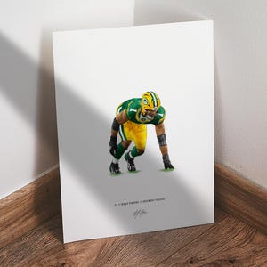 May include: A print featuring an American football player in a green and yellow uniform, in a low stance. The player is wearing a helmet and pads. The print includes the text "#1 Micah Parsons / Green Bay Packers" and a signature.