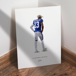 May include: A vertical art print featuring a football player wearing a blue jersey with the name BECKHAM JR and the number 13 in white. The player wears grey pants and white arm sleeves. Text at the bottom reads 13 // ODELL BECKHAM JR // NEW YORK GIANTS.