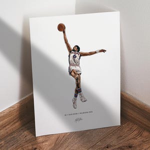 May include: A print of a basketball player in a white and blue uniform, mid-air, reaching for a brown basketball. The player is wearing the number 6. The print has the text "#6 / Julius Erving / Philadelphia 76ers" and a signature.