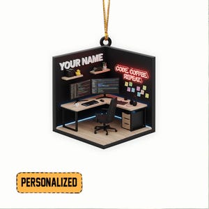 May include: A personalized ornament featuring a miniature computer workspace. The black and light wood desk has two monitors, a keyboard, and a black office chair. The words "CODE. COFFEE. REPEAT." are in neon. The ornament has the text "YOUR NAME".