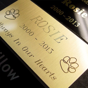 Pet urn memorial metal plaque engraved with paw prints. Perfect memorial for your dog, cat or other loved one.