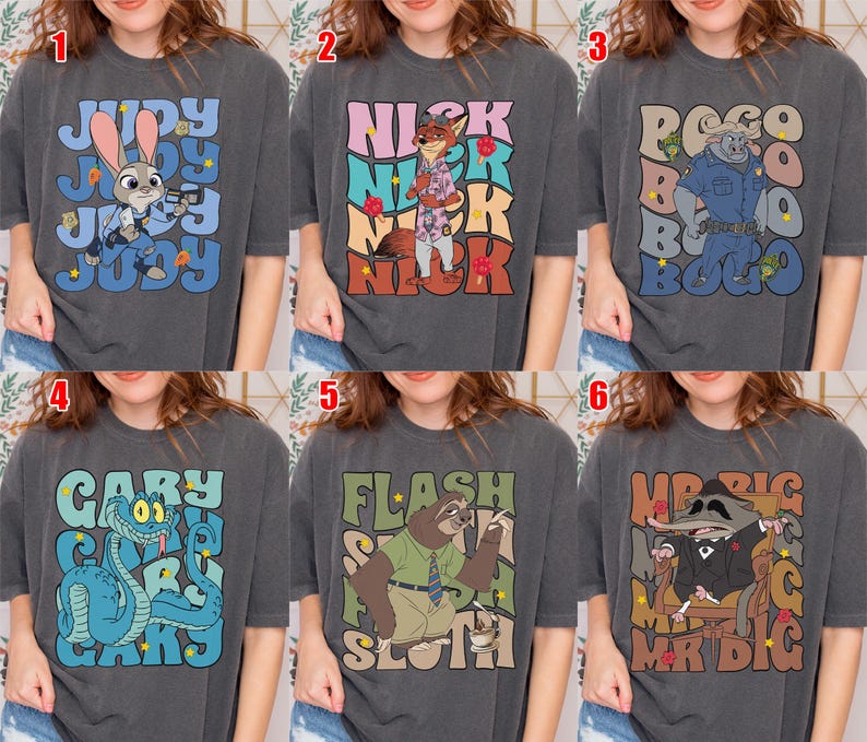 May include: Six dark gray t-shirts with cartoon character designs. The designs include Judy Hopps, Nick Wilde, Chief Bogo, Gary the Snake, Flash the Sloth, and Mr. Big. Each shirt has the character's name.