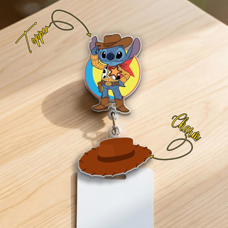 May include: A badge reel featuring a cartoon character dressed as a cowboy. The topper shows the character in a cowboy hat, vest, and boots. A brown cowboy hat charm is attached below. The word "Topper" and "Charm" are written on the image.