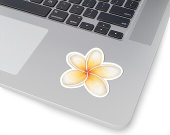 May include: A sticker featuring a watercolor-style plumeria flower. The flower has five rounded petals in shades of yellow and white, with an orange center. The sticker is on a laptop.