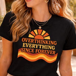 Woman wearing funny overthinking graphic shirt outdoors smiling lifestyle unisex t shirt