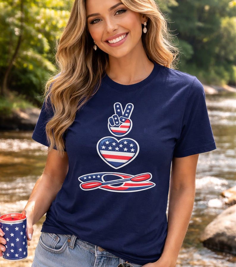 Woman wearing kayaking shirt creek floating design navy blue Bella Canvas 3001 t shirt standing in creek summer outdoor setting