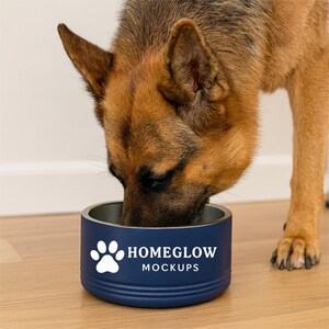 May include: A German Shepherd eating from a navy blue dog bowl. The bowl has a white paw print and the text "HOMEGLOW MOCKUPS". The bowl is on a wooden floor.