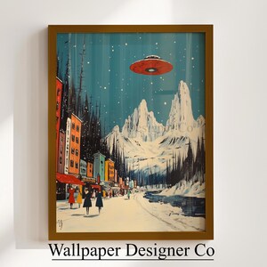 May include: Framed art print showing a winter scene with a red flying saucer above a snowy town and mountains. The artwork features colourful buildings, people, and falling snow. The text "Wallpaper Designer Co" is at the bottom.