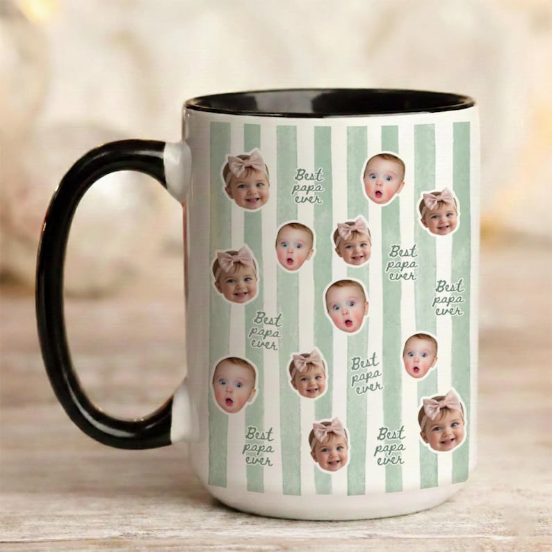 May include: A white ceramic mug with a black handle and interior rim, featuring a light green vertical striped pattern. The mug is decorated with multiple circular photo cutouts of a baby wearing a bow and the repeated text Best papa ever.