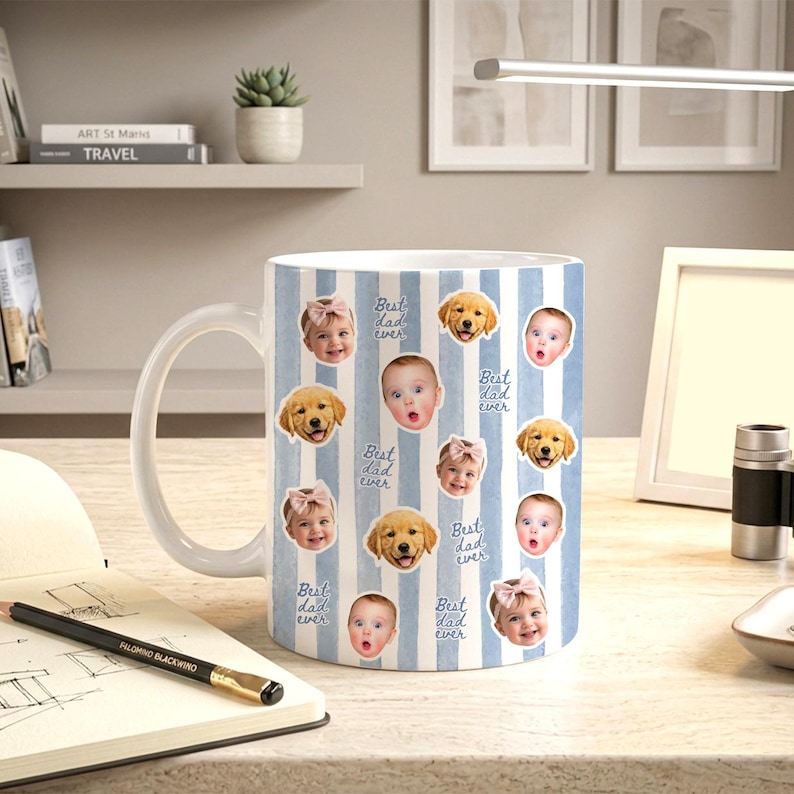 May include: A white ceramic mug featuring a light blue vertical striped pattern. The mug is decorated with repeating circular photo cutouts of a baby and a golden retriever puppy, interspersed with the handwritten blue text Best dad ever.
