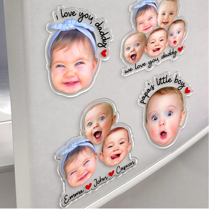 May include: Clear acrylic magnets featuring baby faces with text. One magnet says "I love you, daddy" and another says "we love you, daddy". Other magnets say "papa's little boy", "Emma", "John", and "Cagxon". Each magnet has a red heart.