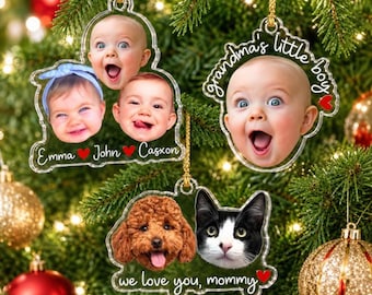 May include: Three clear acrylic Christmas ornaments featuring custom photo prints. One displays three baby faces with the names Emma, John, and Casxon. Another shows a baby face with the text Grandma's little boy. The third shows a dog and cat.