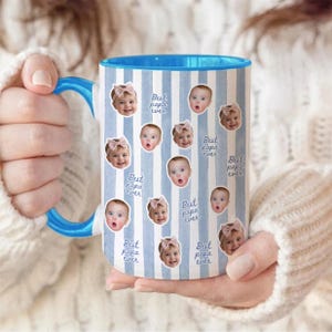 May include: A ceramic mug with a light blue and white vertical striped pattern. The mug features repeated circular photo cutouts of a baby wearing a pink bow, interspersed with the repeating blue cursive text that reads Best papa ever.