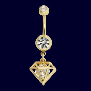 May include: A gold-colored belly button ring with a curved barbell design. It features a small, clear gemstone at the top, a larger gemstone in the center, and a diamond-shaped charm with a clear gemstone at the bottom. The background is a dark blue.