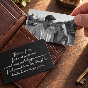 May include: A black metal wallet card featuring white engraved text that reads: To the one I love, I just want you to know you make every simple day feel wonderful. I look forward to walking through life hand in hand with you forever.