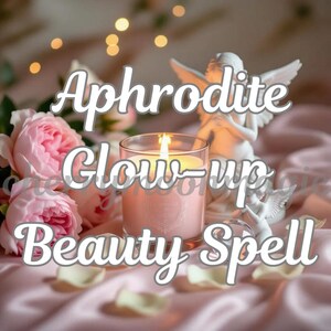 May include: A lit pink candle in a clear glass, with the text "Aphrodite Glow-up Beauty Spell" in white script. The candle sits on a pink satin surface, with pink roses and a white angel statue in the background.