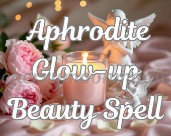 May include: A lit pink candle in a clear glass, with the text "Aphrodite Glow-up Beauty Spell" in white script. The candle sits on a pink satin surface, with pink roses and a white angel statue in the background.
