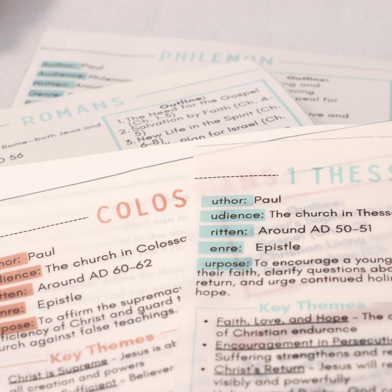 May include: Close-up of several study cards with text. The cards are white with pastel-colored text and headings. The cards include the names of books of the Bible, such as Romans, Colossians, and 1 Thessalonians, along with key themes and outlines.