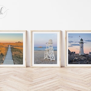 May include: Three framed photographs of beach scenes. The first shows a wooden walkway leading to a small island in the distance. The second shows a white lifeguard chair on a sandy beach. The third shows a white lighthouse on a rocky shore.