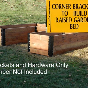 May include: Corner brackets for building a raised garden bed. The brackets are black metal and are attached to a wooden structure. The sign reads "Corner Brackets to Build Raised Garden Bed". Brackets and hardware only, lumber not included.