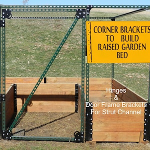 May include: A green metal frame with black corner brackets and hinges. The frame is used to build a raised garden bed. The sign reads "Corner Brackets to Build Raised Garden Bed".