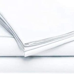 May include: A stack of crisp, white bed sheets. The sheets are neatly folded, with visible creases and a smooth, clean appearance. The image highlights the bright white color and the texture of the fabric, suggesting a fresh and clean bedding set.