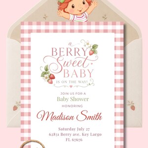 May include: A rectangular baby shower invitation card featuring a pink and white gingham border, decorated with strawberry illustrations and a cartoon character. The text reads: a BERRY sweet BABY IS ON THE WAY! JOIN US FOR A Baby Shower HONORING Madison Smith Saturday July 27 62831 Berry ave. Key Largo FL 67676.