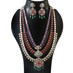 May include: A white ceramic mug with a black handle and the text "But First, Coffee" in a handwritten style. The mug is on a white surface. The mug is approximately 4 inches tall.