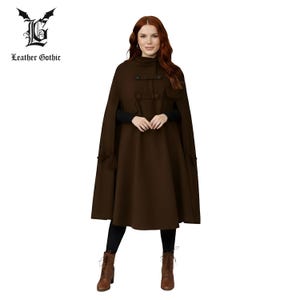 Puede incluir: Una capa marrón con cuello alto y botones decorativos. La capa presenta una silueta acampanada y forma parte de la colección Leather Gothic. La capa se combina con leggings negros y botas marrones.