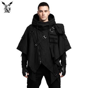 May include: Black hooded jacket with asymmetrical design, featuring a high collar, multiple pockets, and straps with buckles. The jacket has a unique, modern aesthetic, suitable for streetwear or alternative fashion.