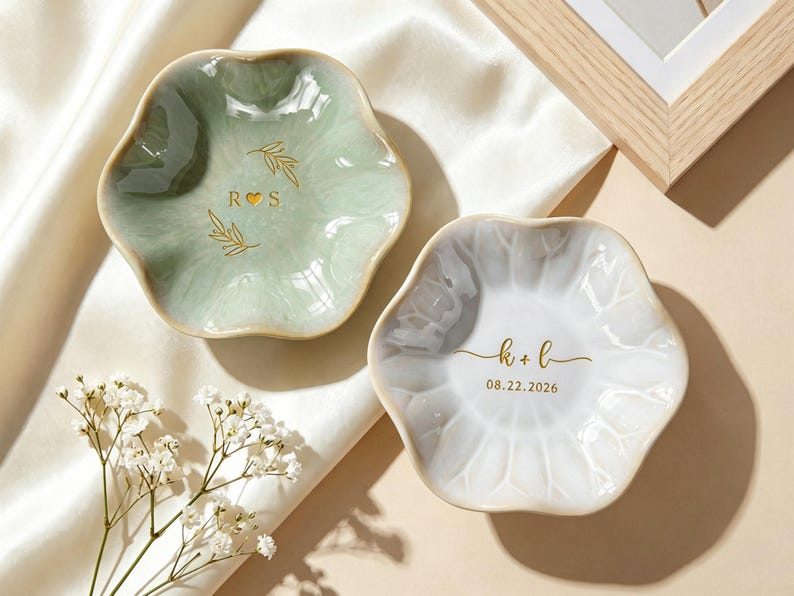 May include: Two scalloped ceramic trinket dishes, one in sage green and one in white. The green dish features gold text R heart S with leaf accents. The white dish displays gold text k + l and the date 08.22.2026 in a clean, elegant font.