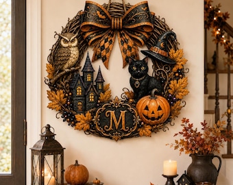 May include: A circular Halloween wreath featuring a large black and orange patterned bow at the top, a perched owl, a miniature haunted house, a black cat wearing a witch hat, a jack-o'-lantern, and a central plaque with the letter M.