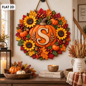 May include: A circular autumn wreath featuring a large central orange pumpkin with the letter S, surrounded by yellow sunflowers, smaller orange pumpkins, red berries, and multicolored fall leaves. The wreath hangs by a rope on a wall.